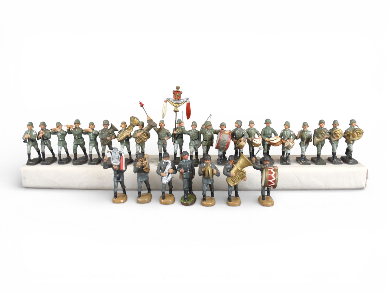 Composition Band Figures: 28 Composition band figures. Various makers including Duro, Leyla, Lineol, and others. Some wear. Shipping: Weiss Auctions offers full-service, in-house shipping for nearly all items in this