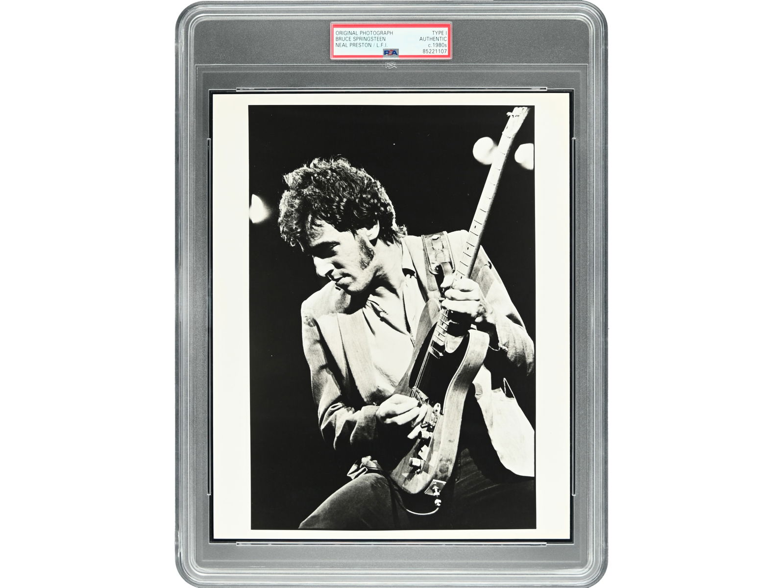 Bruce Springsteen Photo - Type I, Neal Preston: Original Type I photograph of Bruce Springsteen performing live, circa 1980s. Issued by Neal Preston / L.F.I. 8 x 10 black-and-white image authenticated by PSA/DNA.Shipping: Weiss Auctions offers
