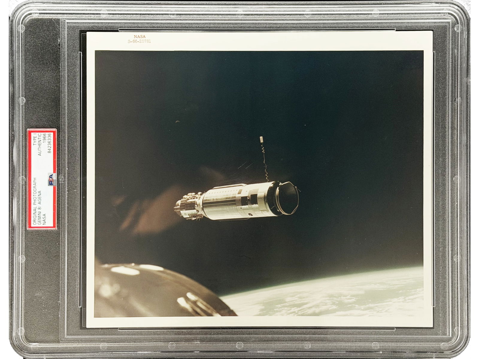Gemini 8 Agena Photo - Type I: Original NASA-issued Type I photograph showing the Agena Target Docking Vehicle as seen from Gemini 8, 1966. Documents the first successful docking of two spacecraft and the mission's critical