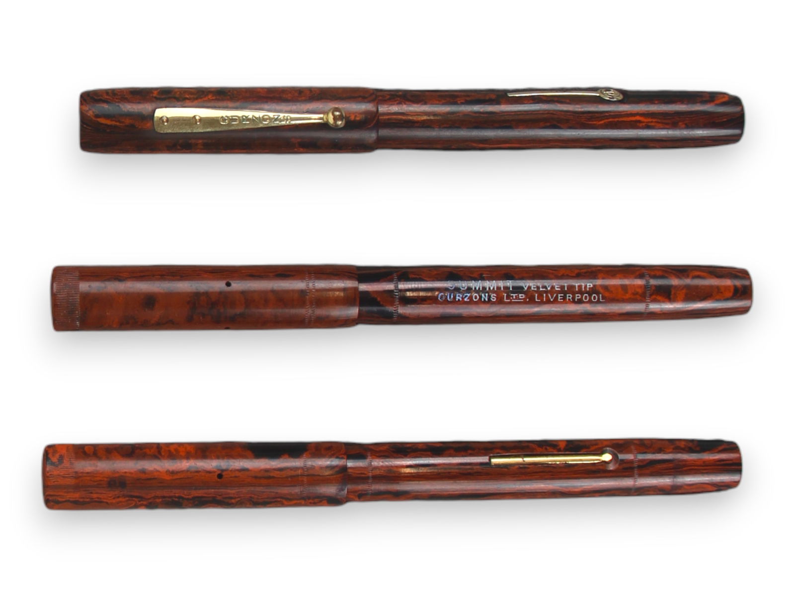 (3) Curzon Summit RHR Fountain Pens: 3 Curzon rippled red hard rubber fountain pens including 2 Velvet Tip (models not marked) and Summit S.75 Velvet Tip. Minor wear, if any. 14k gold nibs, 2 of which are flexible. Not