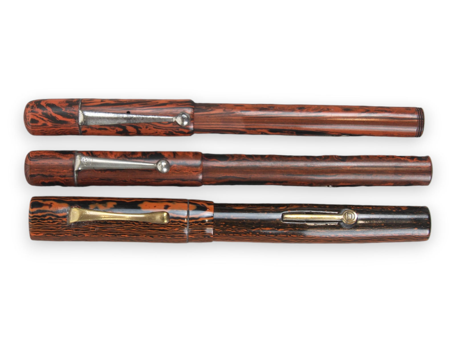 (3) Rippled Red Hard Rubber Fountain Pens: 3 Rippled Red Hard Rubber Fountain Pens De La Run, Epoc, and Diamond Point. 14k gold flexible nibs. Minor wear. Not restored.Shipping: Weiss Auctions offers full-service, in-house shipping for nearly