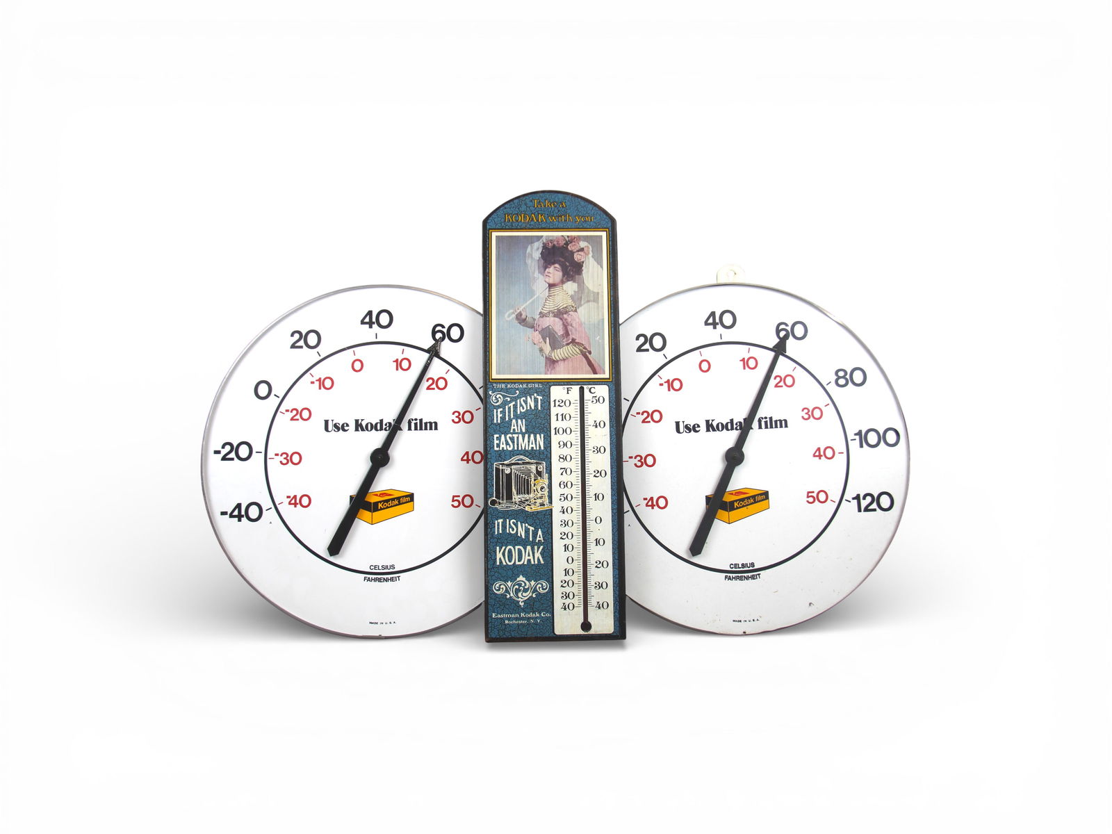 (3) Kodak Advertising Thermometers: Includes (2) tin circular thermometers, each approx. 18" diameter, and wooden thermometer "Take a Kodak with You", approx. 23" x 7". Each appears to be in working condition. All show some edge and sur