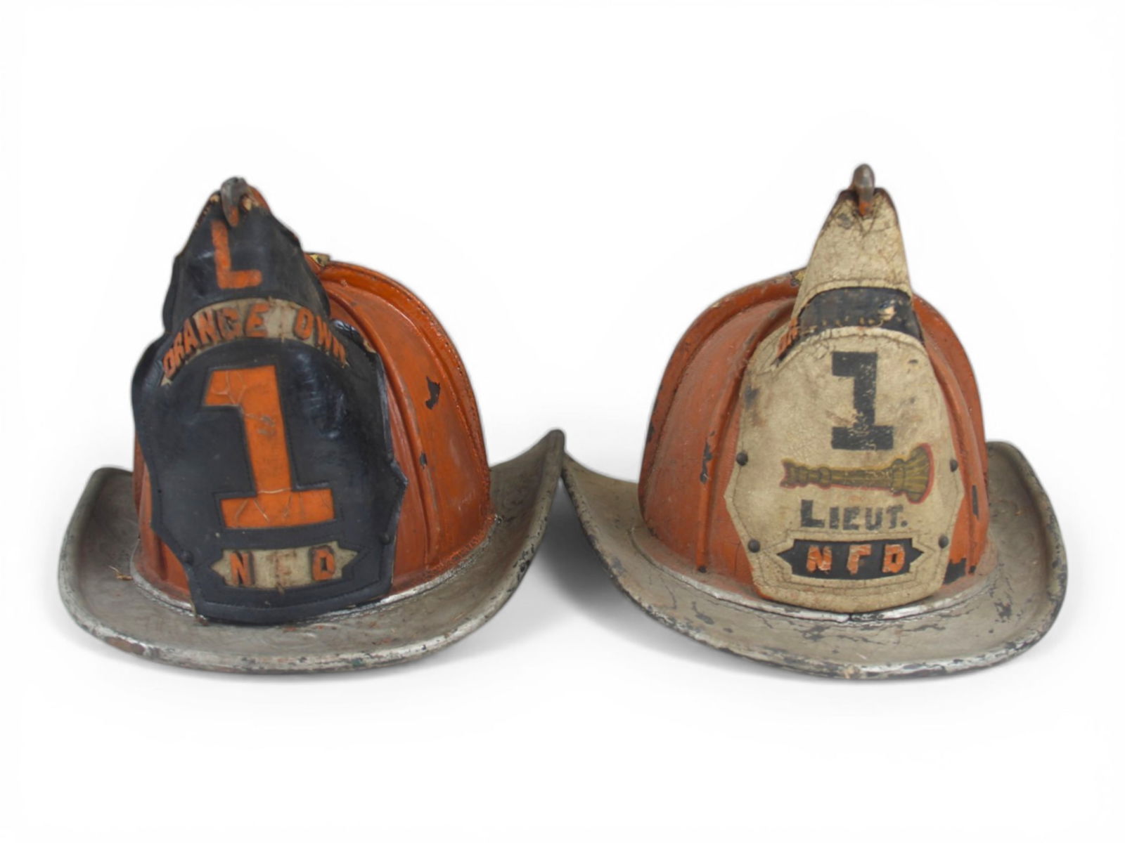(2) Orangetown NFD Leather Fire Helmets: Group of two vintage leather fire helmets to Orangetown Fire Department. One helmet features a front shield marked with a large company number "1" with bugle, and "LIEUT. NFD," while the second