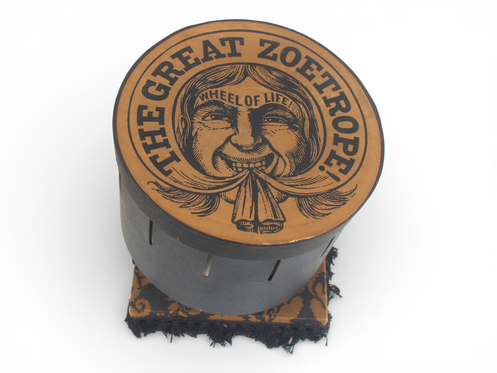 The Great Zoetrope Wheel of Life Viewer: The Great Zoetrope Wheel of Life Viewer. Cardboard slotted drum along with cover, and 12 single sided paper reels with different animations including French Revolution, Roll a Bowl, Raining