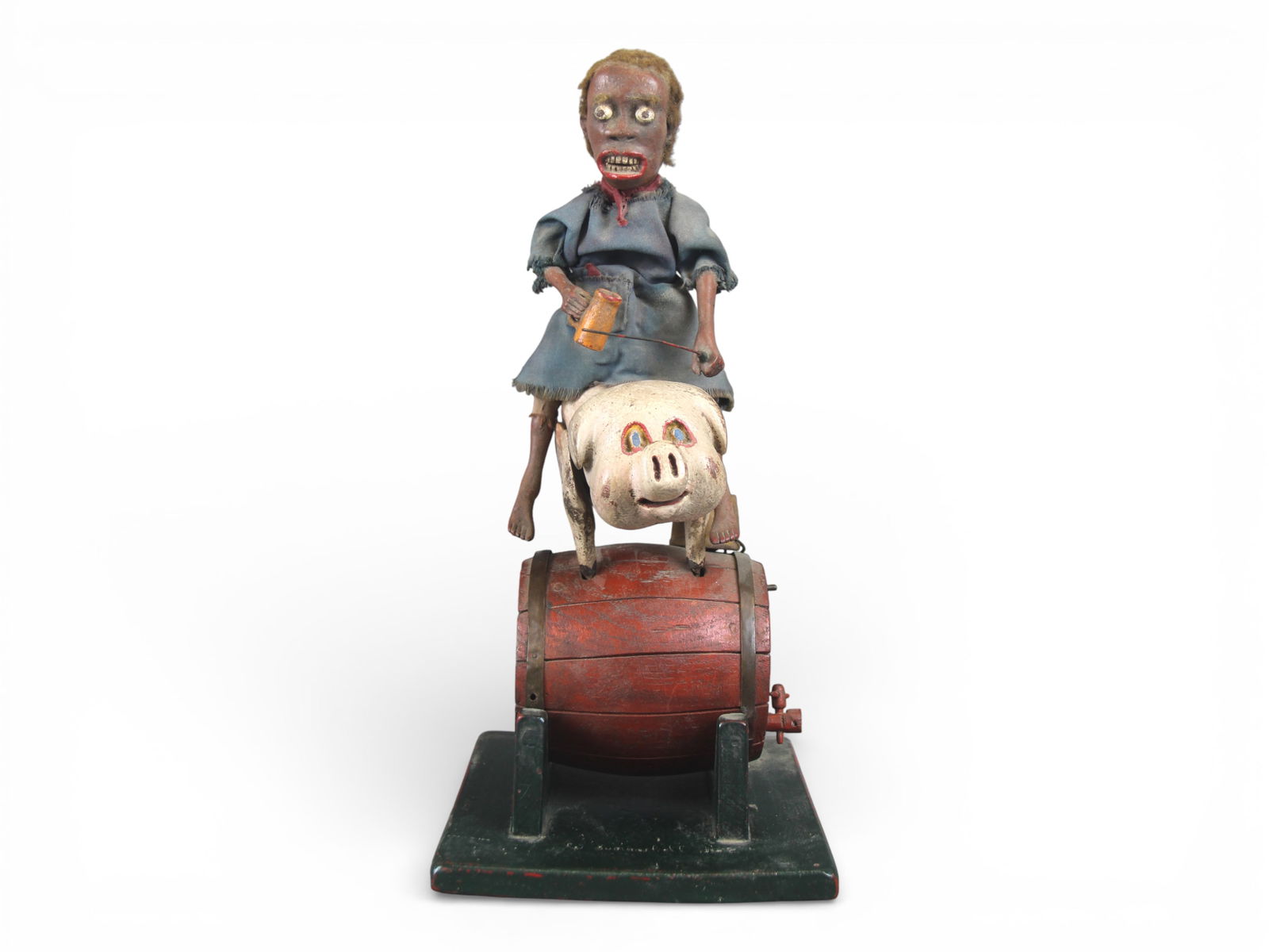 Folk Art Automaton, Figure Riding a Pig: Hand-carved and polychrome folk art automaton depicting a figure seated atop a pig-form mount positioned on a red barrel form base with green supports. The figure features a carved head with applied
