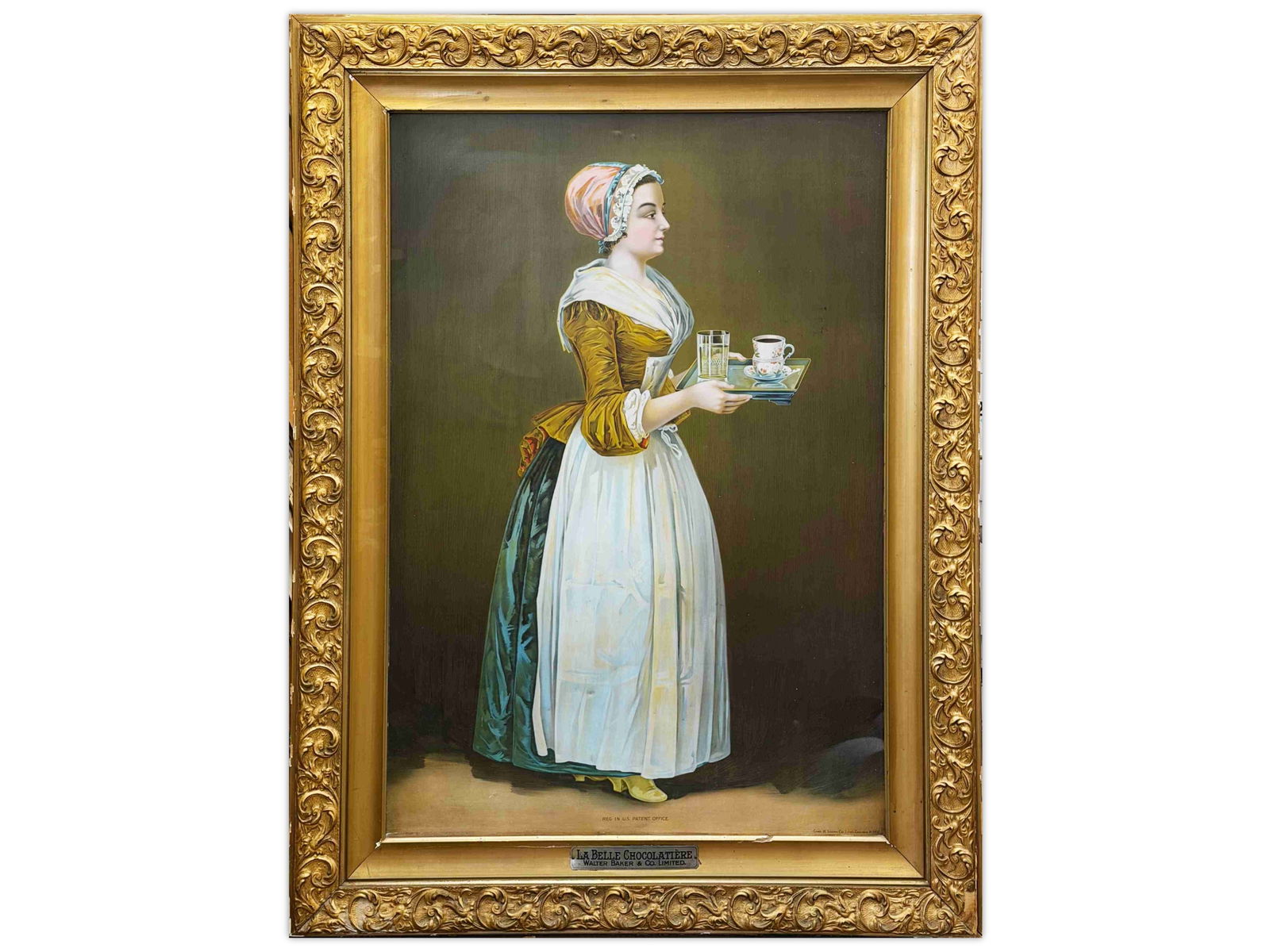 La Belle Chocolatiere Tin Advertising Sign: SST, self-framed tin advertising sign for La Belle Chocolatiere, Walter Baker & Co. Limited. The sign features the iconic maid in period dress and apron presenting a serving tray with chocolate and