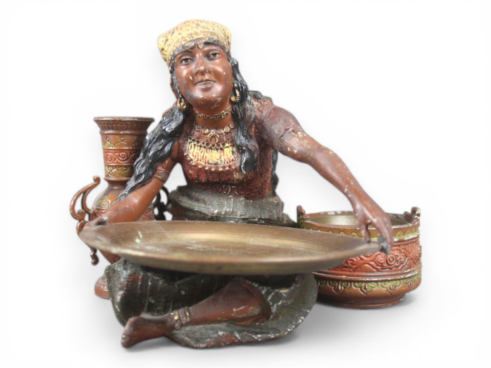 Cold Painted Metal Gypsy Lady Smoking Stand: Approx 9 x 7 inches overall. The figural stand depicts a seated woman in traditional dress holding a shallow tray at the front, intended for use as an ashtray. The figure is flanked by two