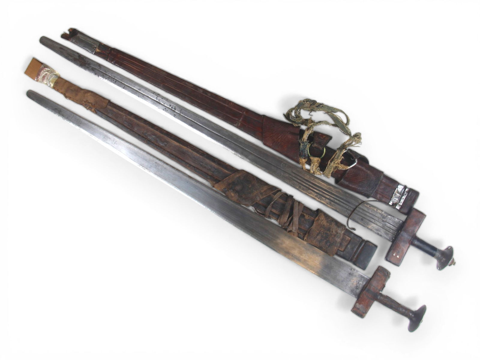 (2) Tuareg Takouba Broad Swords: 2 Tuareg Takouba Broad Swords with scabbards. Total length of each approx. 38''.Shipping: Weiss Auctions offers full-service, in-house shipping for nearly all items in this auction. For a shipping