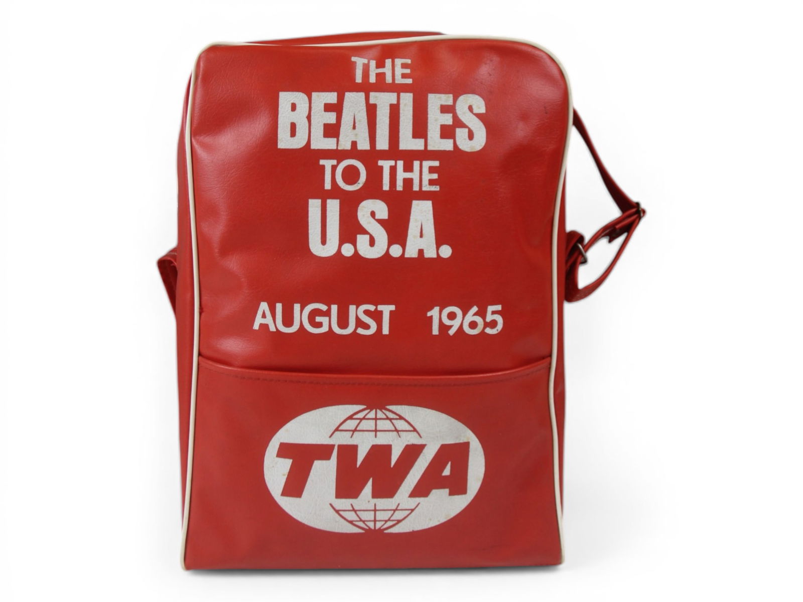 The Beatles to the USA 1965 TWA Airline Carry Bag: Vintage red TWA "The Beatles To The U.S.A. August 1965" Airline carry on travel bag. When the Beatles left London on August 13, 1965 and headed on a TWA plane to New York City, TWA was wise enough to