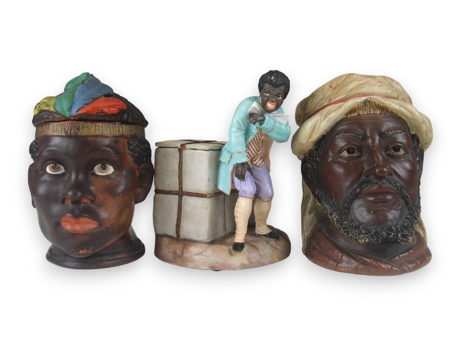 (3) Black Themed Tobacco Jars: All Approx.. 7 1/2" tall with signs of wear. See images for details. Shipping: Weiss Auctions offers full-service, in-house shipping for nearly all items in this auction. For a shipping quote, please