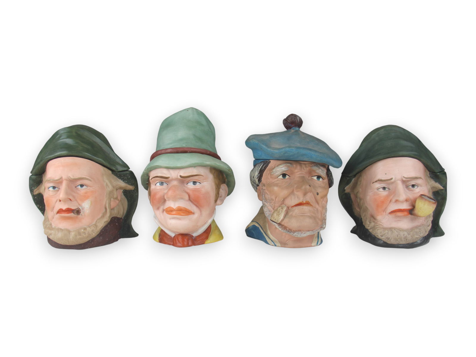 (4) Figural Head Tobacco Jars: 6 1/2-7 1/2" tall each. Some wear. See images for details. Shipping: Weiss Auctions offers full-service, in-house shipping for nearly all items in this auction. For a shipping quote, please contact us