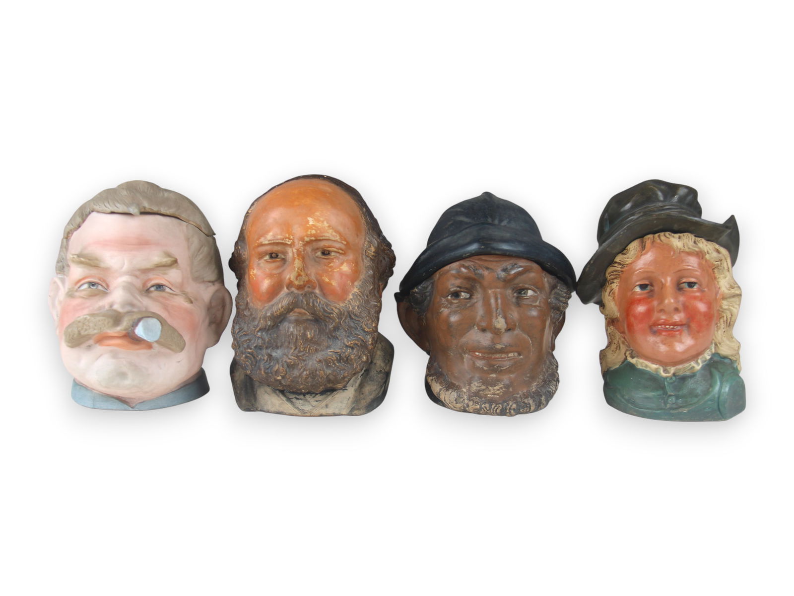 (4) Figural Head Tobacco Jars: 6 1/2-7 1/2" tall each. Some wear. See images for details. Shipping: Weiss Auctions offers full-service, in-house shipping for nearly all items in this auction. For a shipping quote, please contact us