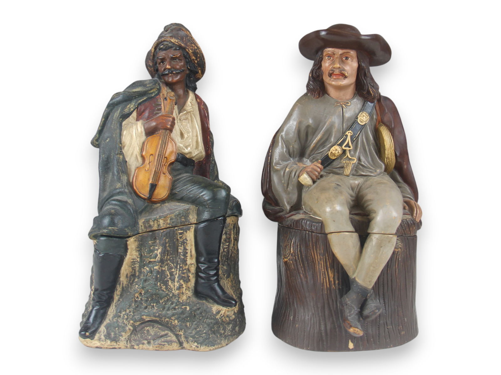(2) Terra Cotta Tobacco Jars: "Cavaliers" Each Approx. 10 1/2" tall Some wear evident Shipping: Weiss Auctions offers full-service, in-house shipping for nearly all items in this auction. For a shipping quote, please contact us pr