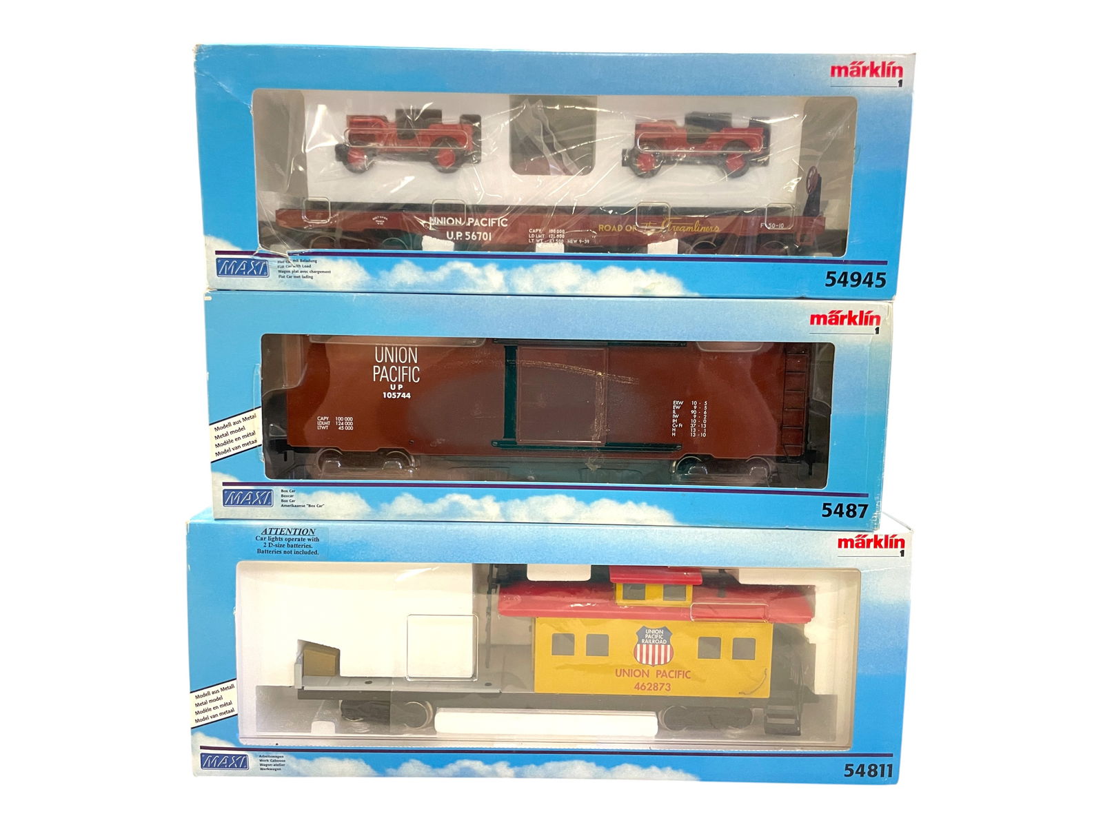 3 Marklin Maxi UP Freight Cars: 1/G Gauge. Enamel Painted Pressed Steel. Includes 5487 UP Boxcar; 54945 UP Flat with US Jeeps; 54811 UP Work Caboose with searchlight. All show light use with boxes.Shipping: Weiss Auctions offers