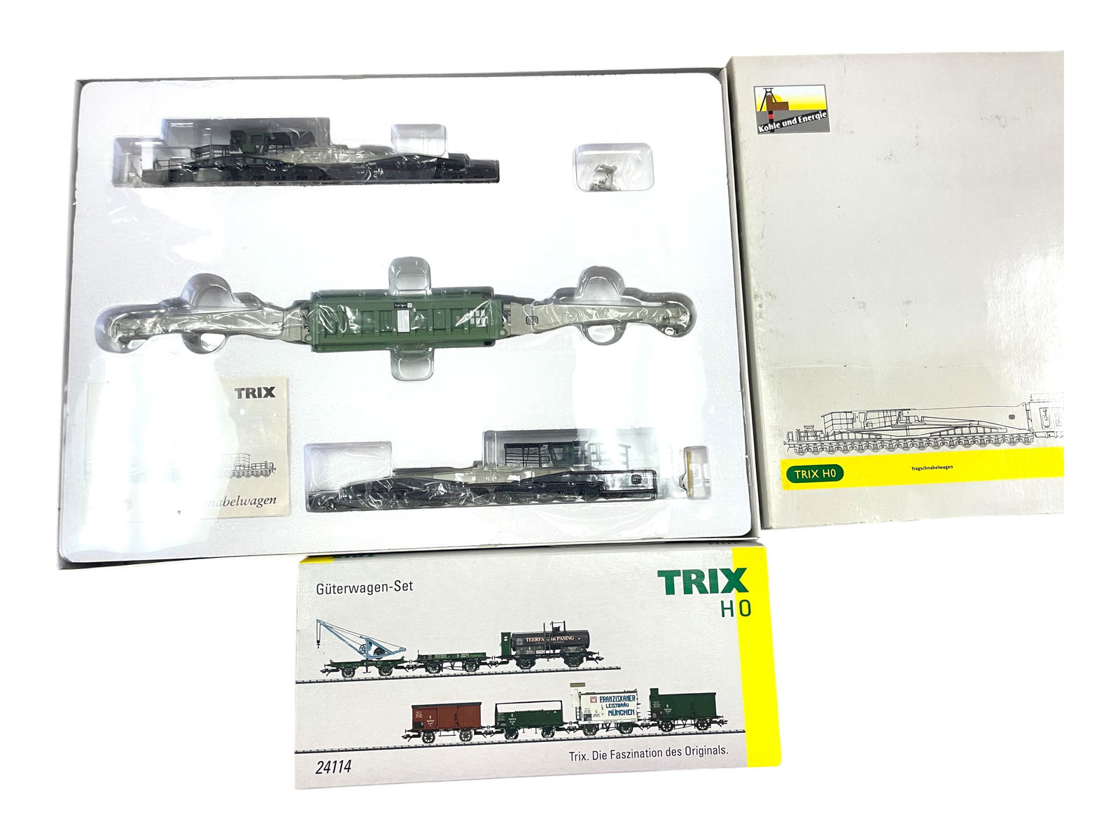 2 Trix Freight Car Sets: HO Gauge. Includes a 23994 Extreme Heavy Load Car set; 24114 7pc early 20th century style 7pc freight car set. All appear like new with boxes. Shipping: Weiss Auctions offers full-service, in-house sh