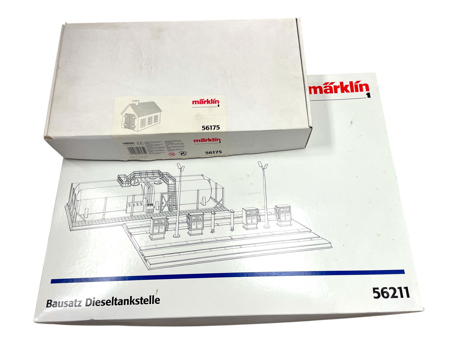 2 Boxed Marklin Maxi Structure Kits: 1/G Gauge. Includes a 56211 Diesel Fueling Station; 56175 Small Engine Shed. Both appear unbuilt with boxes. Shipping: Weiss Auctions offers full-service, in-house shipping for nearly all items in thi