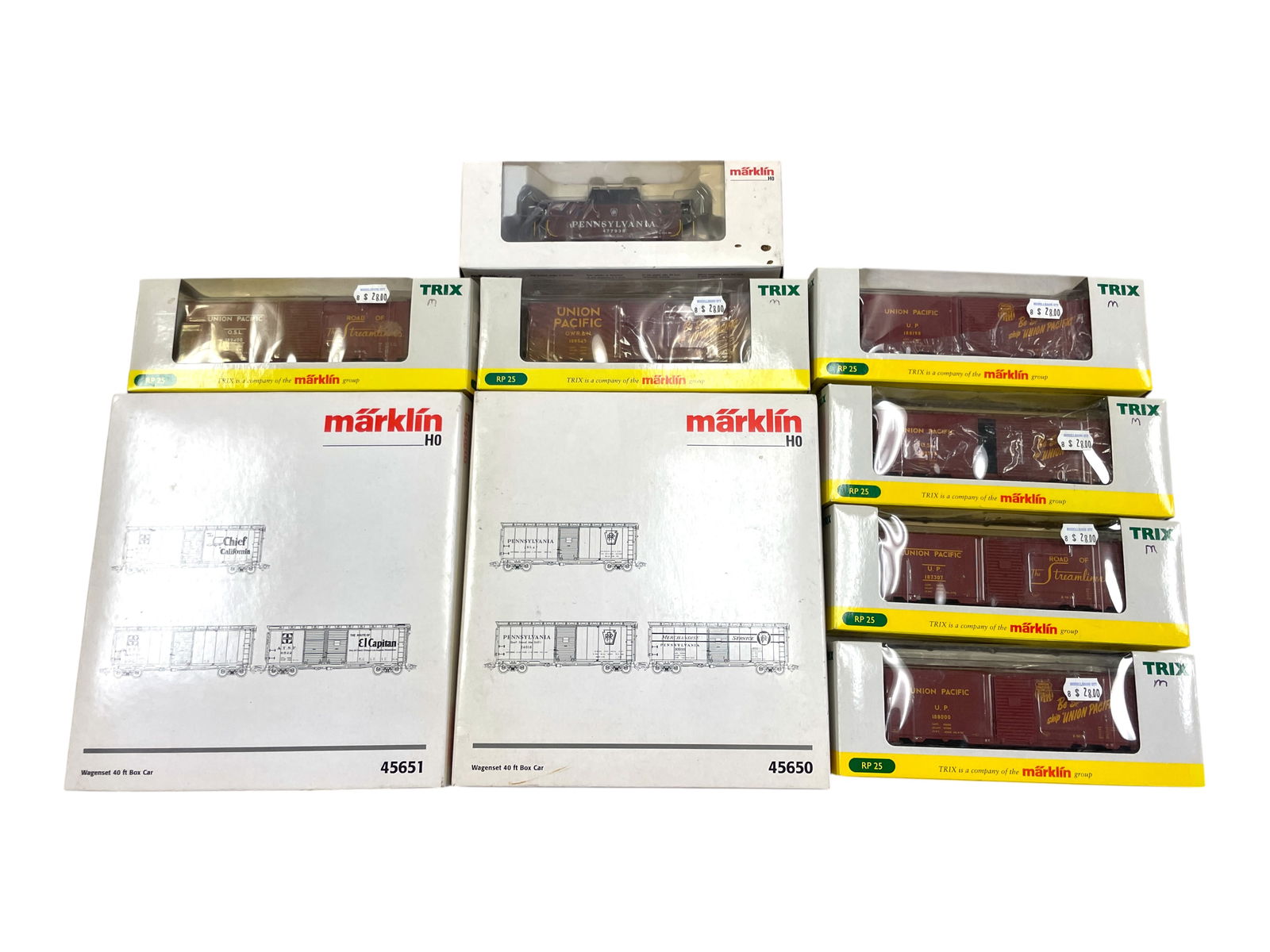 Marklin & Trix HO American Freight Cars: HO Gauge. Includes 6 Trix 24900 RP25 UP boxcars, all different road numbers; Marklin 45650 PRR boxcar 3pk; 45651 ATSF 3pk Boxcars. Marklin 45705 PRR N5c Caboose. They appear new in boxes. Shipping: We