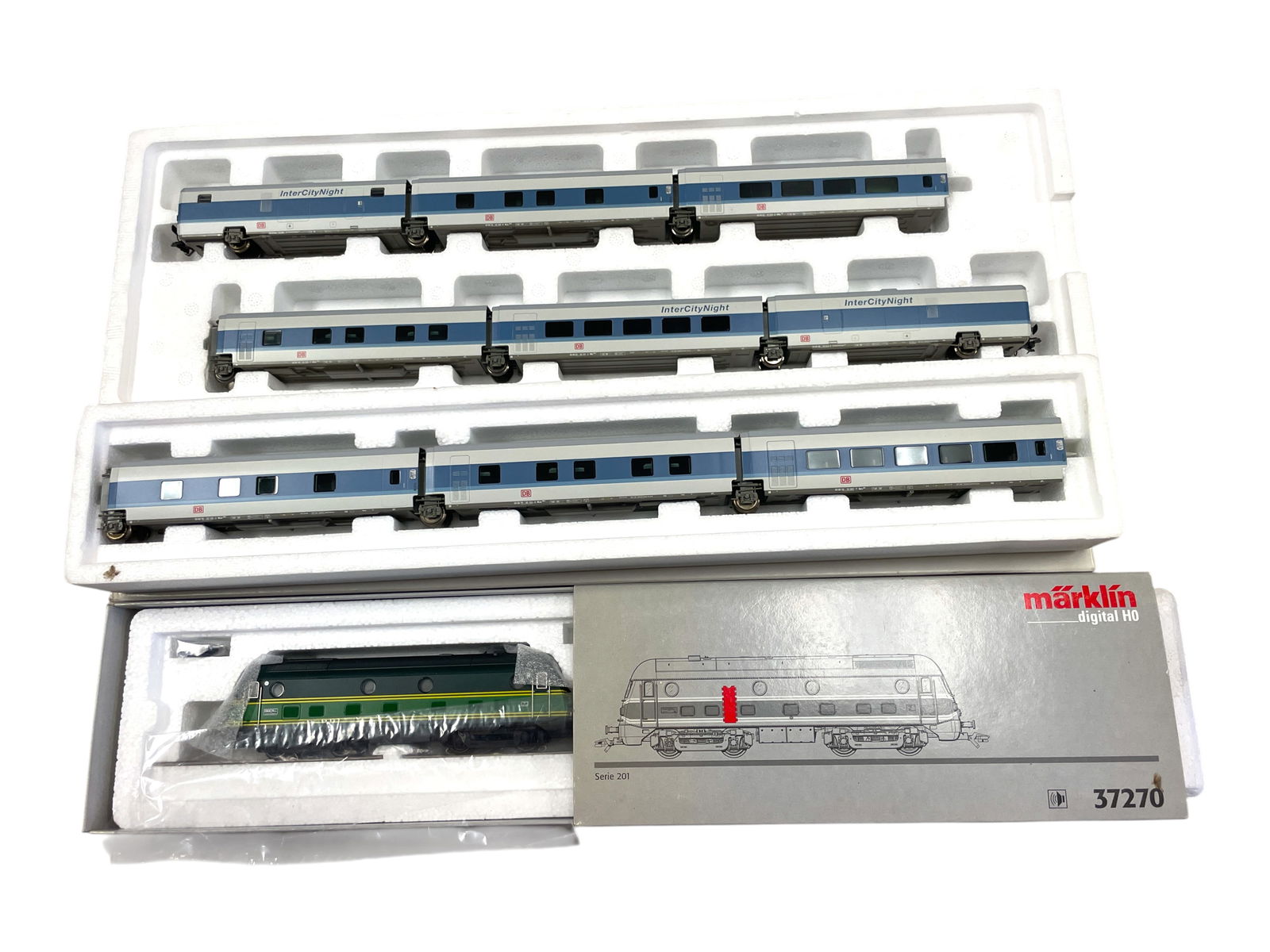 Marklin HO Belgian InterCity night Set: HO Gauge. Includes a 37270 Serie 201 Belgian diesel with sound; 41771 & 41772 9pc car sets. All appear like new with boxes Shipping: Weiss Auctions offers full-service, in-house shipping for nearly al
