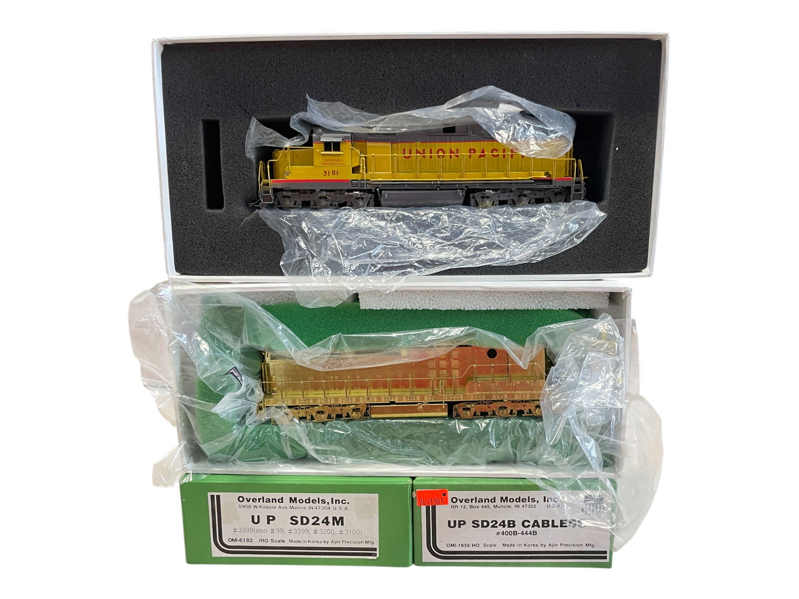 Overland Brass HO UP SD24M & B Diesels: HO Gauge. Nice Custom Painted UP SD24M diesel, can motor, #3101; Unpainted SD24B Cabless Can Motor Powered B-Unit, like new in box.Shipping: Weiss Auctions offers full-service, in-house shipping for