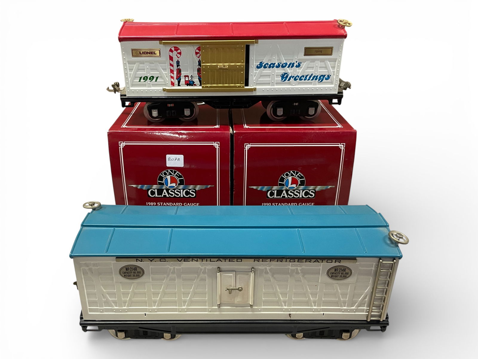 4 Modern Standard Gauge Freights: Standard Gauge. Includes boxed Lionel 13601 & 13602 Christmas Cars with boxes; 13603 Christmas Boxcar, loose; MTH 214R Reefer, No Box. All appear unrun.Shipping: Weiss Auctions offers full-service,