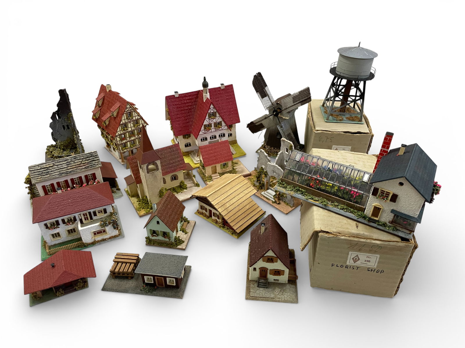 16 German Factory-Built Up Structures: HO Gauge. Includes a boxed Faller 220 Florist Shop & Greenhouse; Boxed Faller 144 Water Tank; RS SPITALER 425 Ruin; RS SPITALER 03 & 04 Bungalows; Faller 286 Challette; Faller Electric Windmill; 2