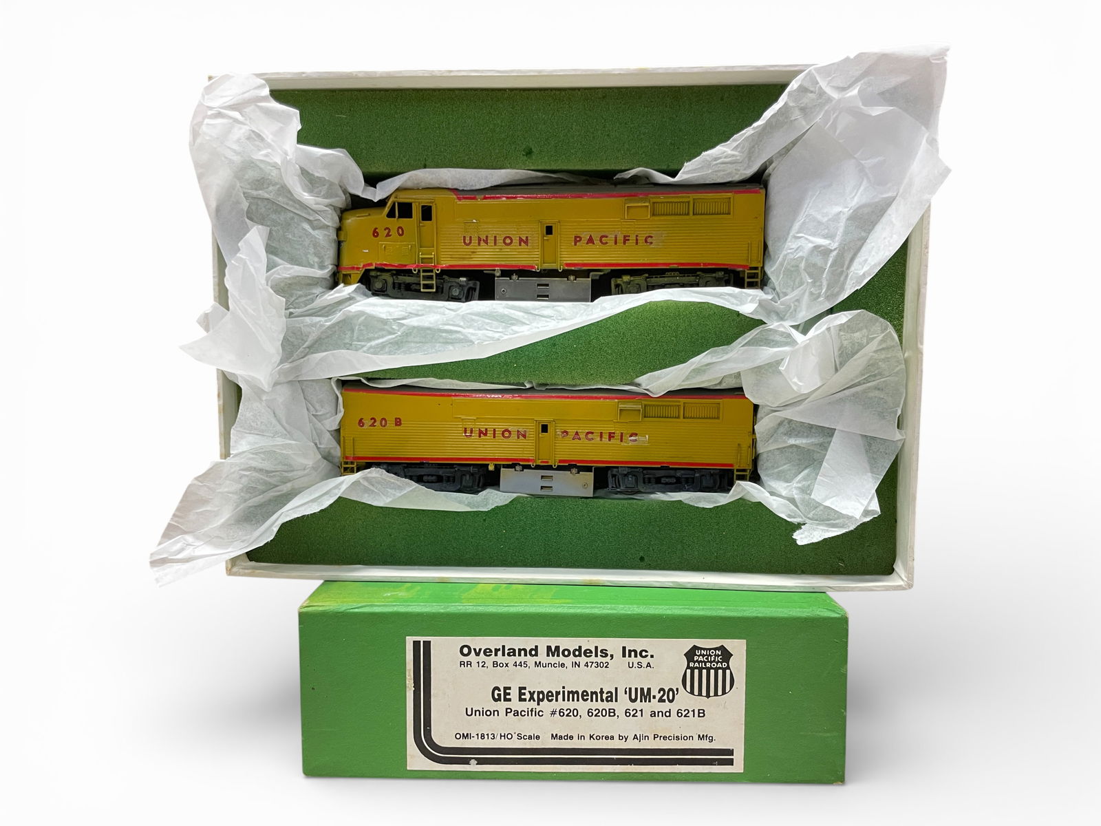 Overland Brass HO Exp UM-20 AB Diesel: HO Gauge. Custom Painted #620 & 620b, both units are powered with can motors. B-Unit missing cab screws, has lights installed. They show light play wear with box.Shipping: Weiss Auctions offers