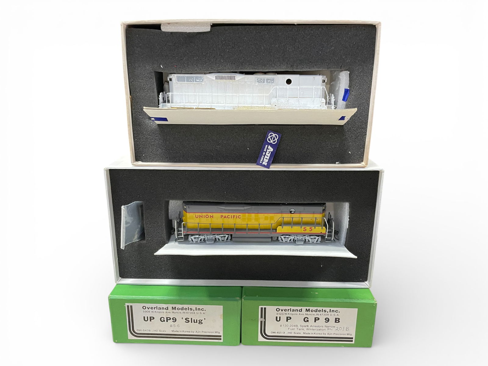 Overland Brass HO UP GP9B & Slug Diesels: HO Gauge. Includes a GP9B, partially painted powered B-Unit; GP9 Slug, factory painted, custom decaled and powered. They show no run time with boxes.Shipping: Weiss Auctions offers full-service,