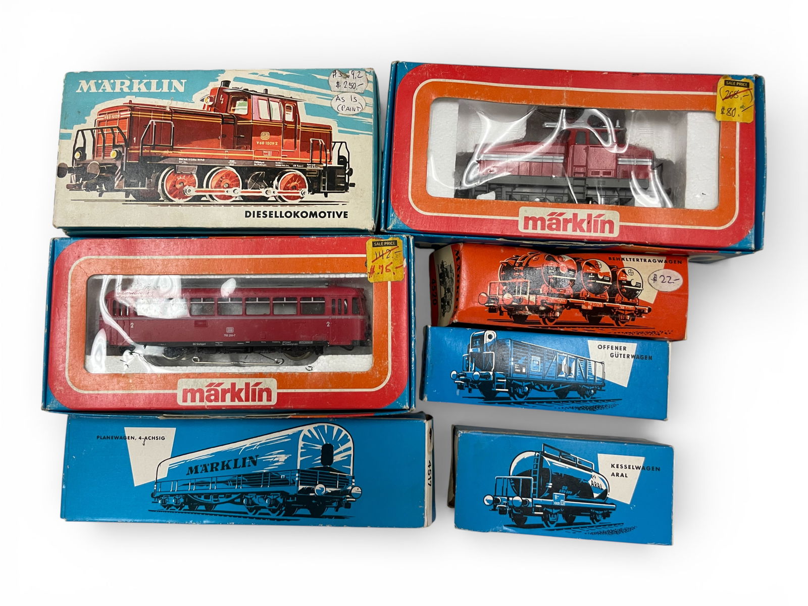 79c Marklin HO Group: HO Gauge. Includes a 3016 V795 Rail Bus; 3044 EA800 Electric; 3069 SNBC Belgian Diesel, some paint flaking; 4520, 4601, 4517 & 4500 wagons, all boxed show some wear.Shipping: Weiss Auctions offers