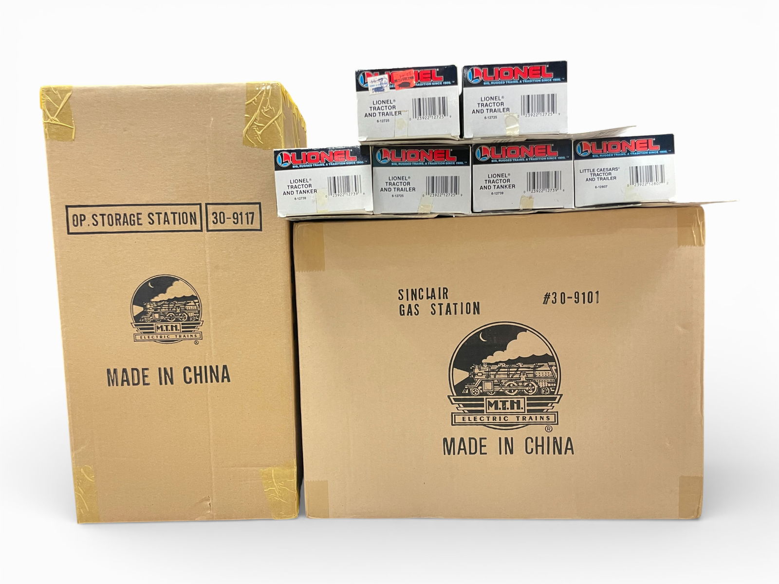 8 Modern Train Accessories: Includes an MTH 30-9101 Sinclair Gas Station & 30-9117 OP Storage Station, both sealed in shippers; Lionel Tractor Trailers- 12725, 2-12739s; 12807; 2-12725s, trucks appear like new with lightly shop
