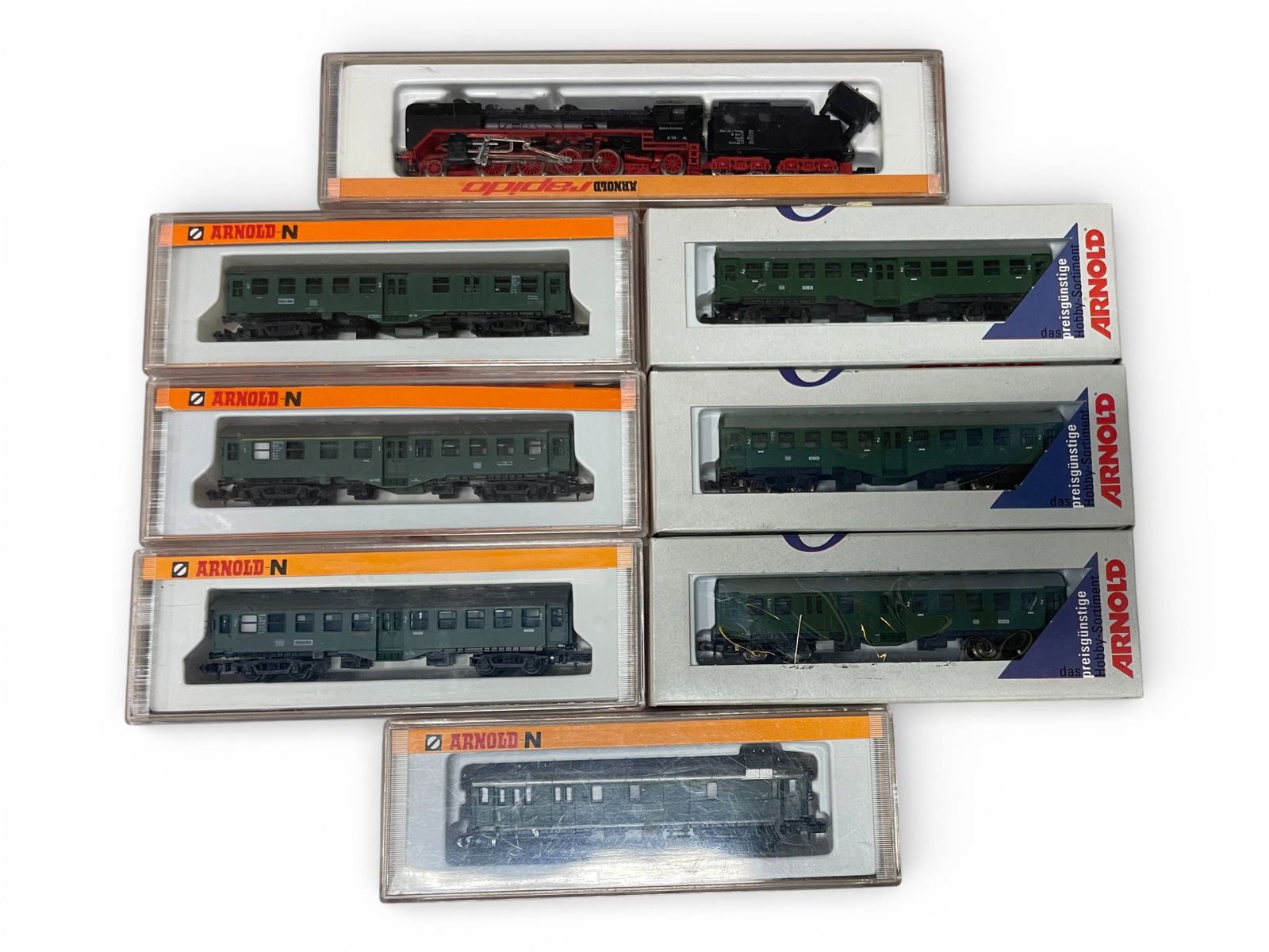 8pc Arnold Rapido Steam Commuter Set: N Gauge. Includes an 0251 DB BR41 166 2-8-2 consolidation steam loco; Cars 3140, 3150, 3160, 5804, 5805, 5806 & 3301. All appear like new with boxes. Shipping: Weiss Auctions offers full-service, in-h