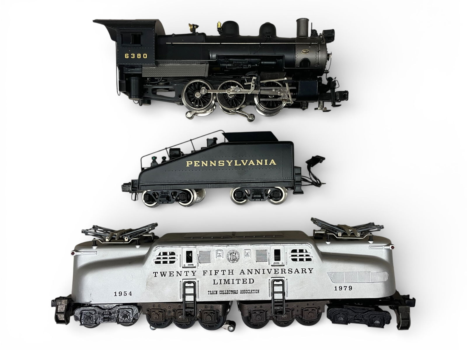2 Williams Locomotives: Includes a Brass 5200 PRR 0-6-0 steam switcher with light & smoke, like new; 1979 TCA Silver Jubilee GG1 showing light play wear. NO boxes.? From The Estate Collection of Joel Cane.Shipping: Weiss