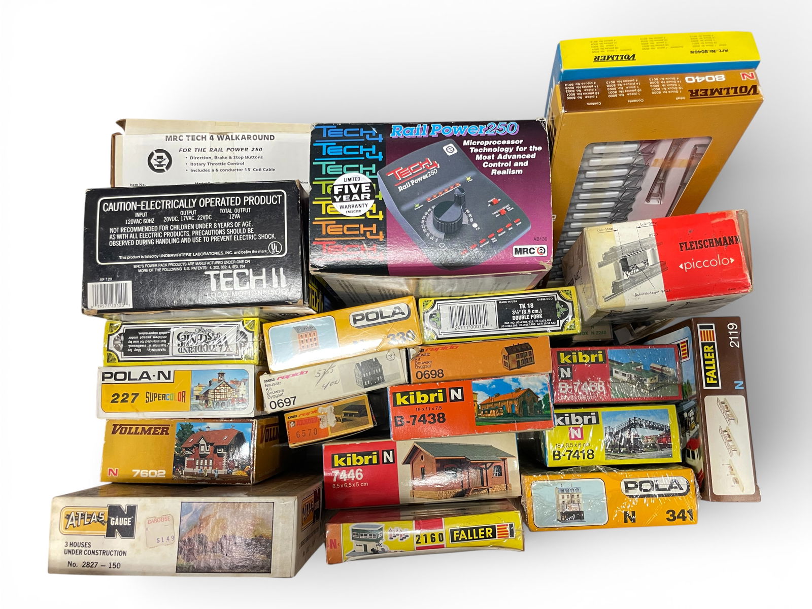 Large Lot N Gauge Accessories & Buildings: N Gauge. Includes a Tech Railpower 250 transformer; Tech Loco-Motion 1500 transformer, several Kibri, Faller, Pola & Vollmer structure kits and some boxed Arnold Rapido track, 2 boxed Vollmer Catenary