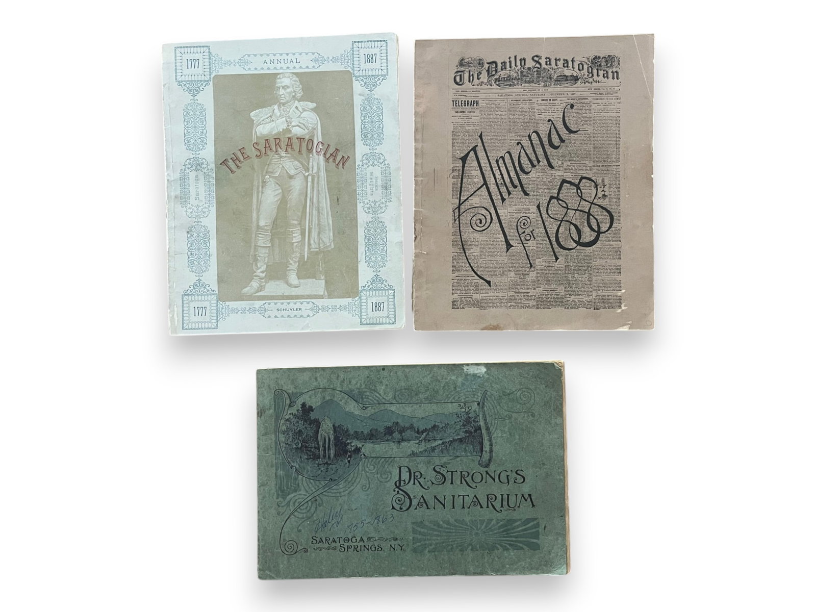 Saratoga Springs (8) volumes in Wraps: Lot includes oblong Dr. Strong's Sanitarium late 19th century, The Daily Saratogian Almanac 1888, the Daily Saratogian Annual 1887 and (5) others .See images for details.From the Collection of James