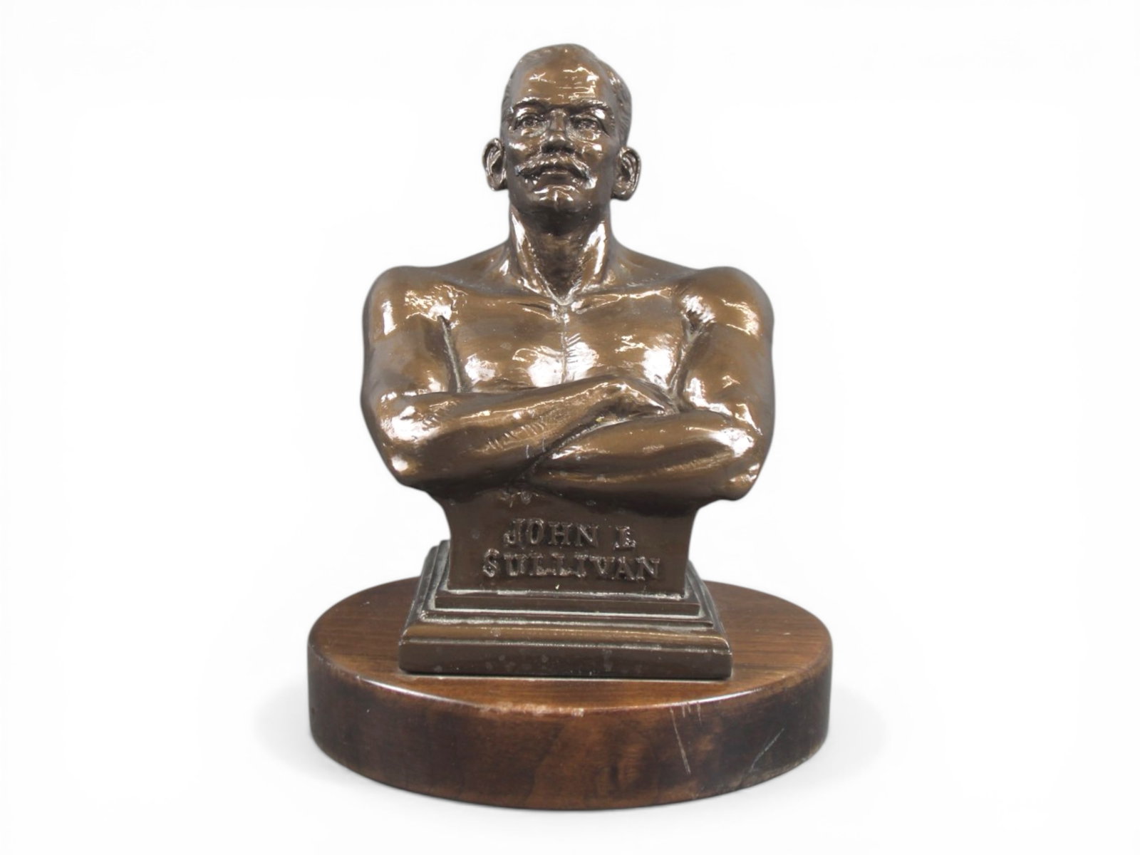 Boxing. John L. Sullivan Bust Statue: Overall approx. 11.5" tall. Bust appears to be chalkware, mounted on wooden base. Signed on the verso "Sheely", and limited edition. Shows light edge and surface wear. Shipping: Weiss Auctions offers 