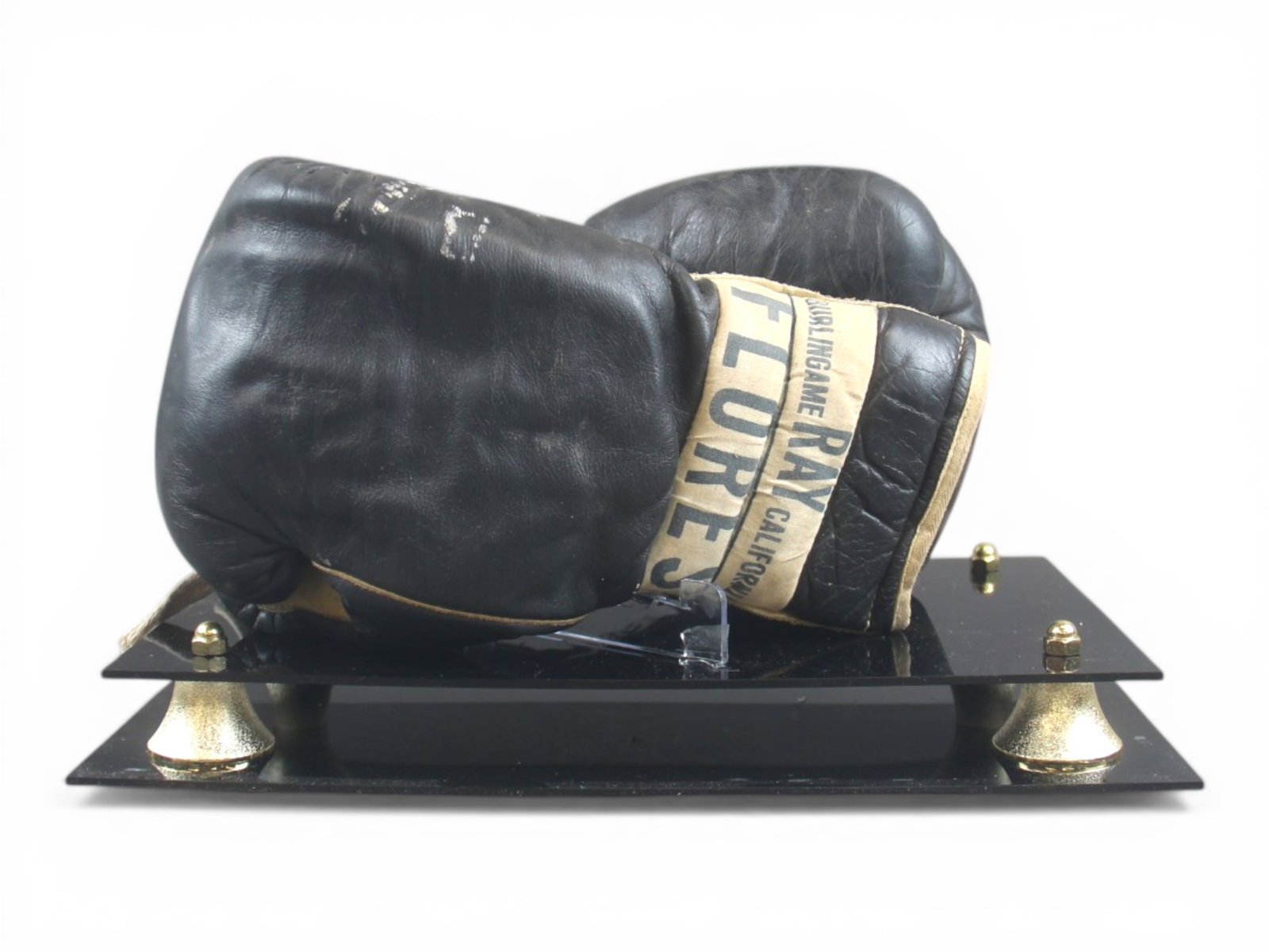 Circa 1950 Ray Flores Black Leather Boxing Gloves: Rare, Ray Flores black leather boxing gloves with white leather thumbs. Original Ray Flores label and original drawer strings. Filled with horse hair, and leather is soft and in good condition. Interi