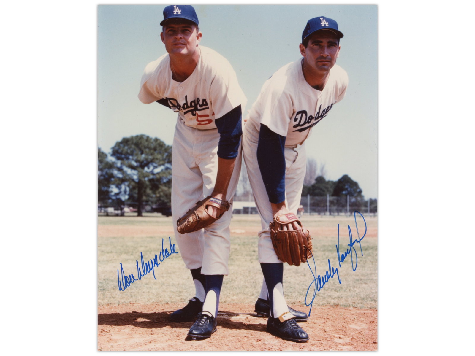 Don Drysdale & Sandy Koufax Signed Photo - JSA: Color 8 x 10 photograph depicting Los Angeles Dodgers pitching legends Don Drysdale and Sandy Koufax leaning forward on the field in a classic posed image. Both players have signed the photograph in b