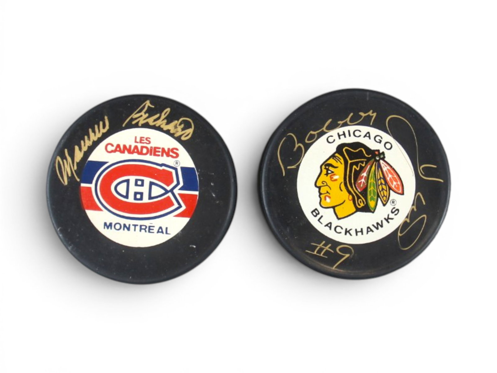(2) Signed Hockey Pucks Richard & Hull: Signed hockey pucks, including one signed by Maurice Richard and one signed by Bobby Hull. Both are signed in gold marker/pen on team-branded pucks. A desirable pair featuring two of the most iconic H