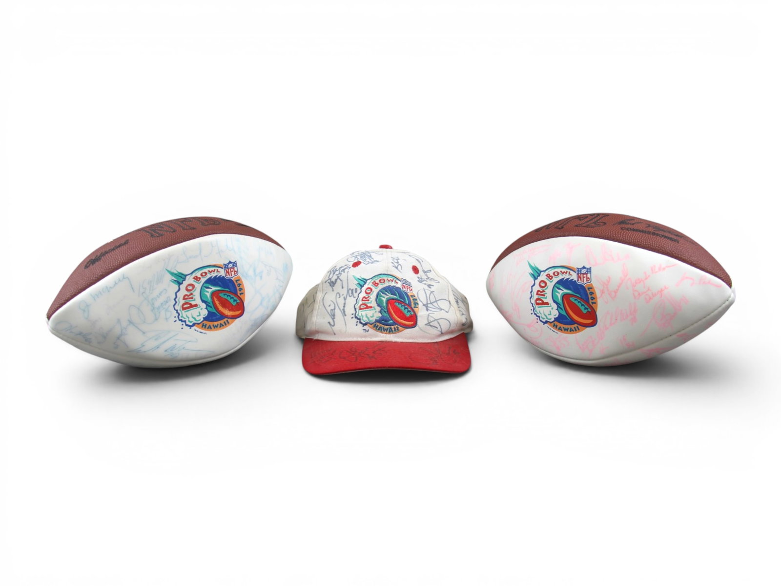 (3) 1997 Pro Bowl Signed Footballs & Hat: Group of three signed 1997 Pro Bowl Hawaii items including two full size Pro Bowl footballs, one signed in blue ink and one signed in pink ink, together with a signed hat. All pieces feature