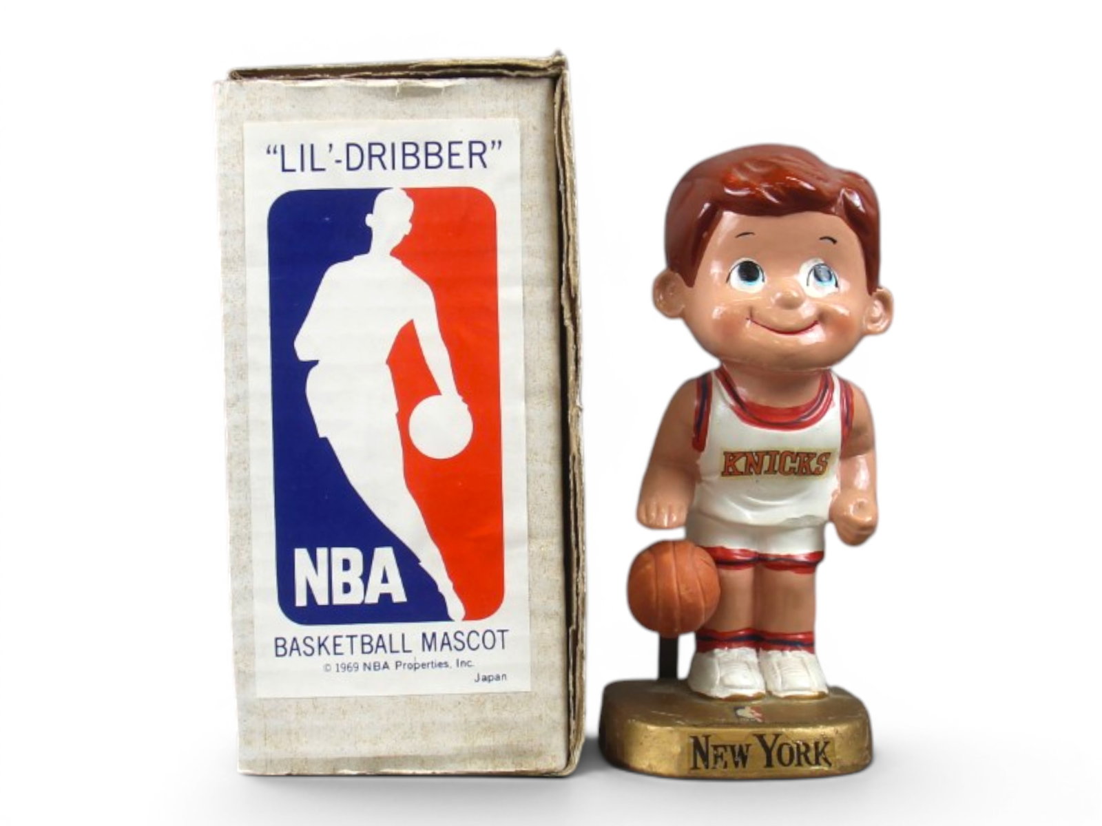 1969 NY Knicks Lil Dribbler Mascot Figure with Box: Offered is a Vintage, 1969 "Lil Dribbler" New York Knicks NBA Mascot statue/figure. Made in Japan. Comes in the original box and includes ball. Approx. 6-1/4" tall. Decals are still present, however s