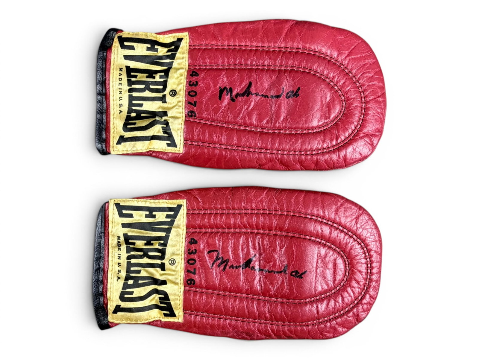 Muhammad Ali Signed Training Mitts: Pair of vintage Everlast training mitts, each signed by Muhammad Ali in black marker. Ali, a three-time heavyweight champion and Olympic gold medalist, remains one of the most influential figures in