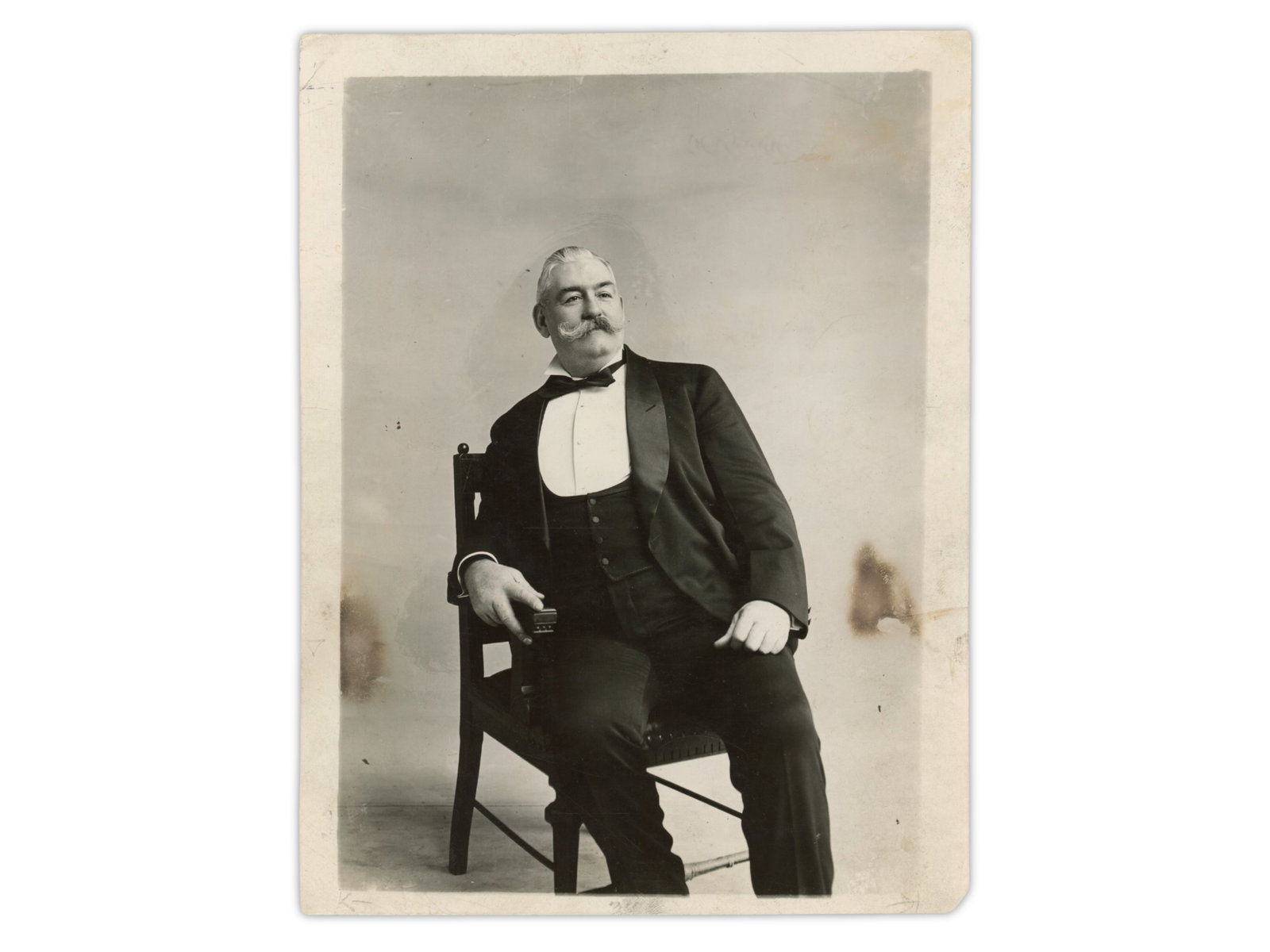 John L. Sullivan Vintage Photograph: 6.5 x 8.5 inch vintage photograph of John L. Sullivan seated in a tuxedo. Sullivan was boxing's first widely recognized Heavyweight Champion and a major figure in the transition from bare-knuckle