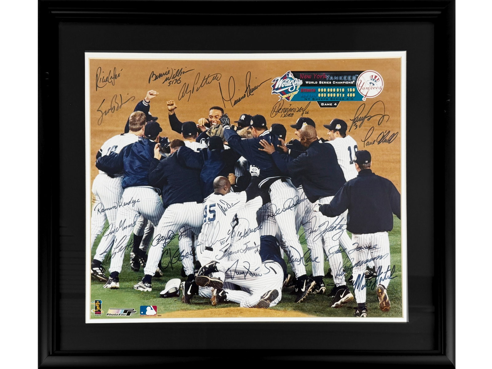 1999 NY Yankees Team Signed Photo: Offered is a 1999 New York Yankees World Series Champion Team Signed Photo, featuring approx. 24 signatures. Includes: Derek Jeter, Mariano Rivera, Orlando Hernandez, Paul O'Neill, Joe Torre, David Co