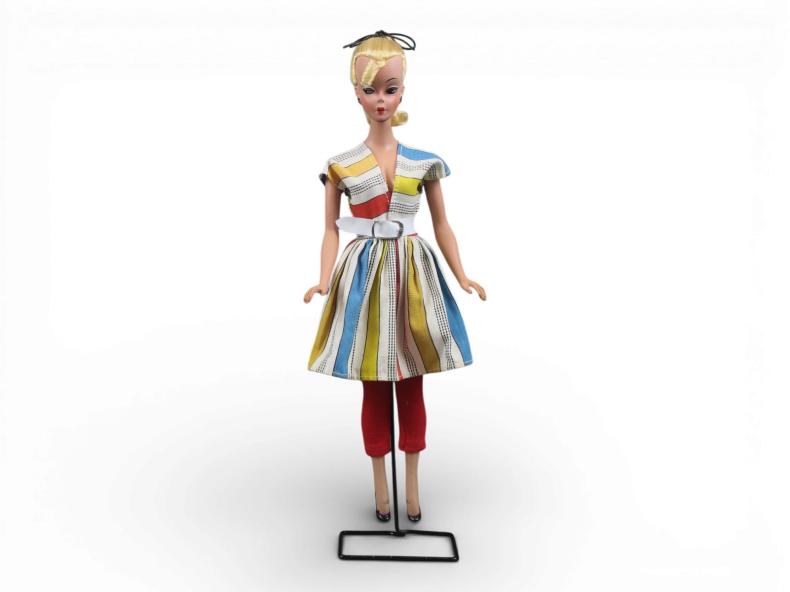 Original German Bild Lilli Doll, 11-1/2": German "Bild Lilli", 11-1/2" doll with molded and painted facial features, side-glancing eyes with molded lashes, high arched eyebrows, blonde inset wig styled in a ponytail with curl on her forehead,