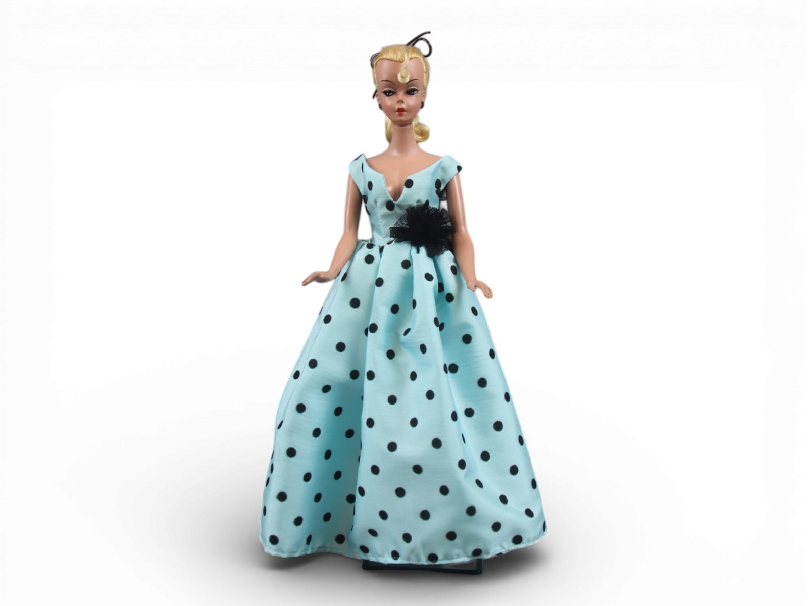 Original German Bild Lilli Doll, 11-1/2": German "Bild Lilli", 11-1/2" doll with molded and painted facial features, side-glancing eyes with molded lashes, high arched eyebrows, blonde inset wig styled in a ponytail with curl on her forehead,