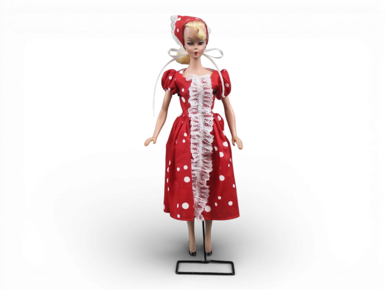 Original German Bild Lilli Doll, 11-1/2": German "Bild Lilli", 11-1/2" doll with molded and painted facial features, side-glancing eyes with molded lashes, high arched eyebrows, blonde inset wig styled in a ponytail with curl on her forehead,