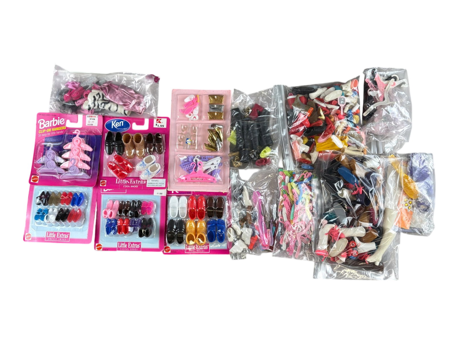 Barbie & Ken Shoes and Hangers: Box lot of Barbie and Ken shoes and hangers, some in original packaging. Mixed vintage assortment. Shipping: Weiss Auctions offers full-service, in-house shipping for nearly all items in this auction.