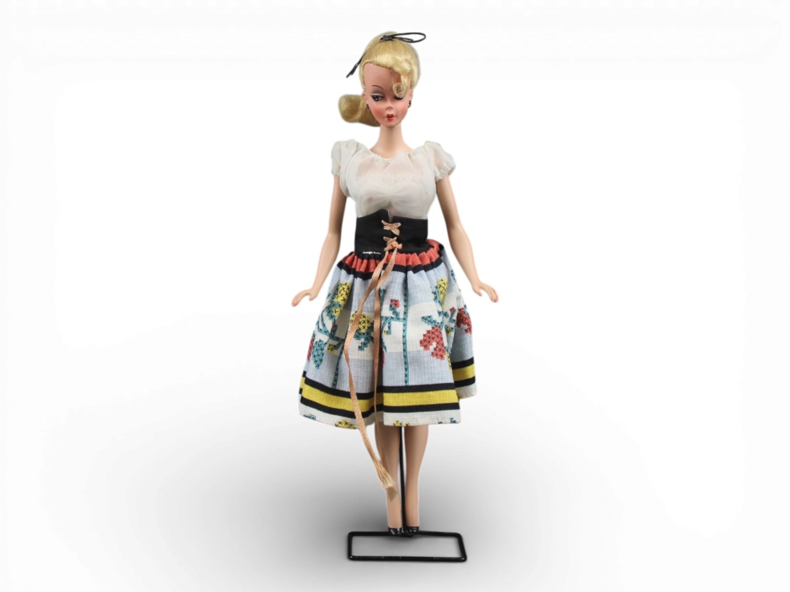 Original German Bild Lilli Doll, 11-1/2": German "Bild Lilli", 11-1/2" doll with molded and painted facial features, side-glancing eyes with molded lashes, high arched eyebrows, blonde inset wig styled in a ponytail with curl on her forehead,
