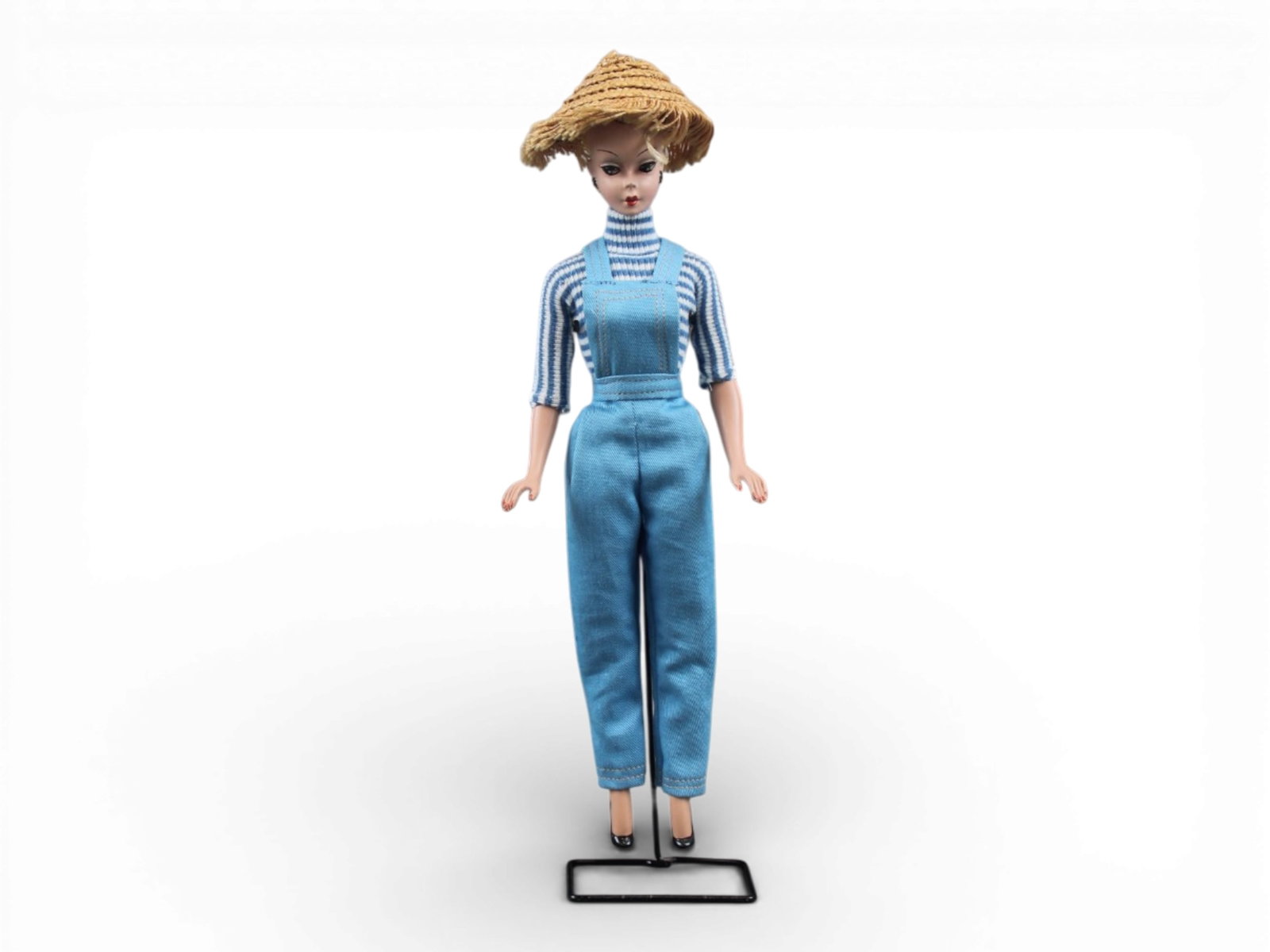 Original German Bild Lilli Doll, 11-1/2": German "Bild Lilli", 11-1/2" doll with molded and painted facial features, side-glancing eyes with molded lashes, high arched eyebrows, blonde inset wig styled in a ponytail with curl on her forehead,