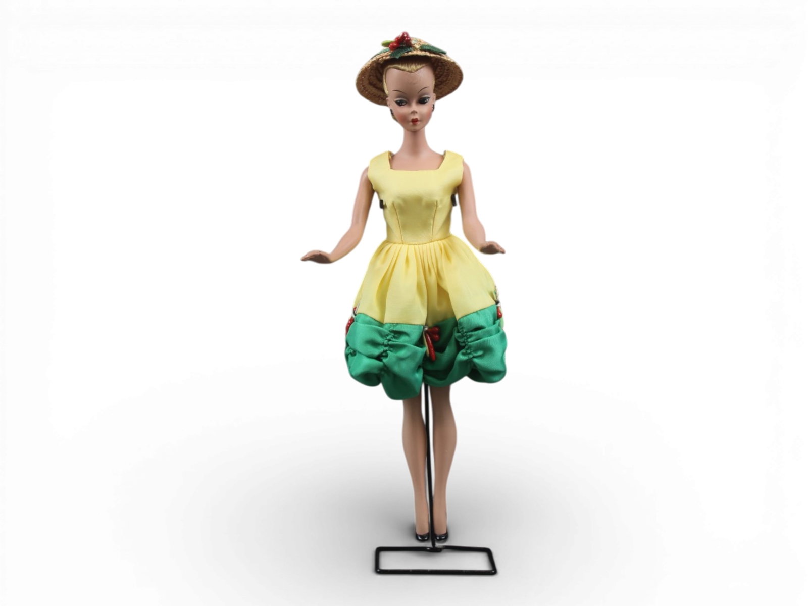 Original German Bild Lilli Doll, 11-1/2": German "Bild Lilli", 11-1/2" doll with molded and painted facial features, side-glancing eyes with molded lashes, high arched eyebrows, blonde inset wig styled in a ponytail, (missing curl on her fore