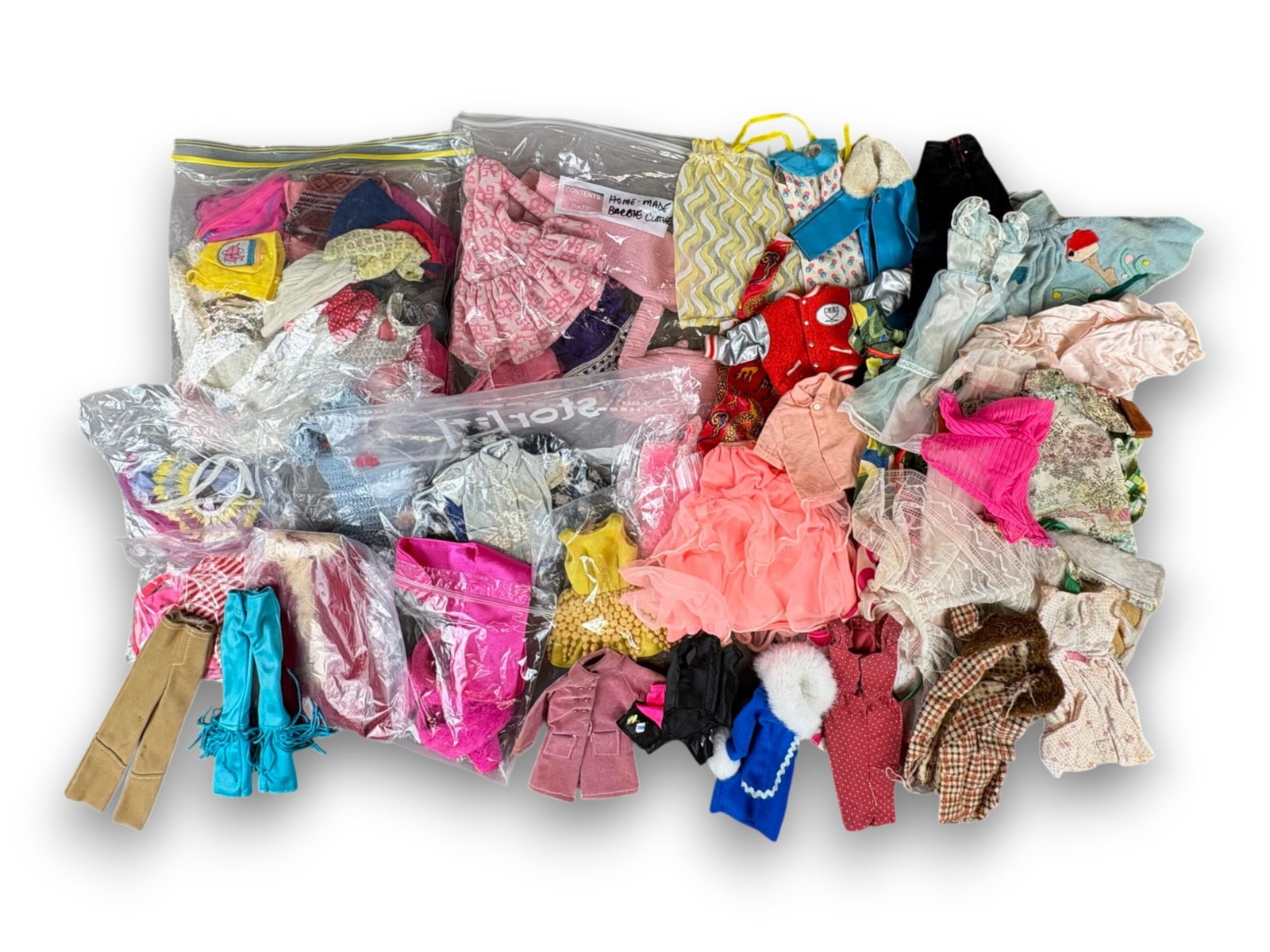 Barbie & Clone Clothes Assortment: Box lot of Barbie and Barbie clone clothing, including handmade pieces. Circa 1960s-1980s. Shipping: Weiss Auctions offers full-service, in-house shipping for nearly all items in this auction. For a